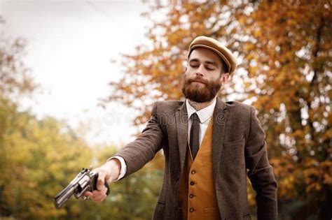 Limit my search to r/gangsta. Retro Gangster With A Beard In An Autumn Park With A Gun ...