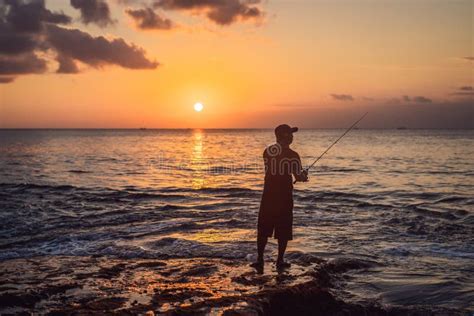 Fisherman Fishes In The Sea At Sunset Stock Image Image Of Ocean