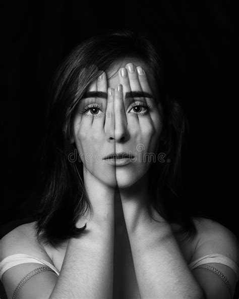 Surreal Portrait Of A Young Girl Covering Her Face And Eyes With Her