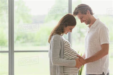 Affectionate Pregnant Couple Touching Stomach Stock Photo Dissolve