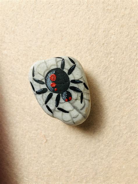 Spider Painted Pebbles With Brush And Tempered Paints Work Break And