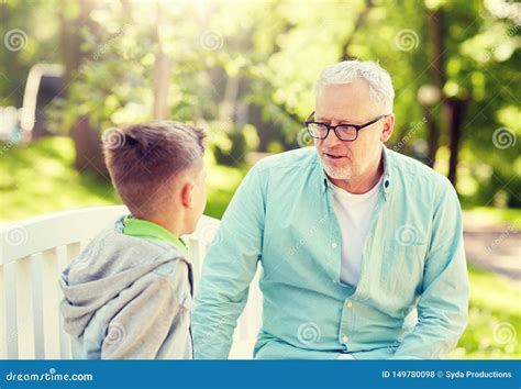 Grandfather And Grandson Talking At Summer Park Stock Photo Image Of