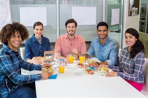 Portrait Of Smiling Executives Having Breakfast Stock Image Image Of