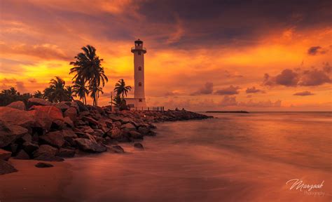 Lighthouse At Sunset By Marzook