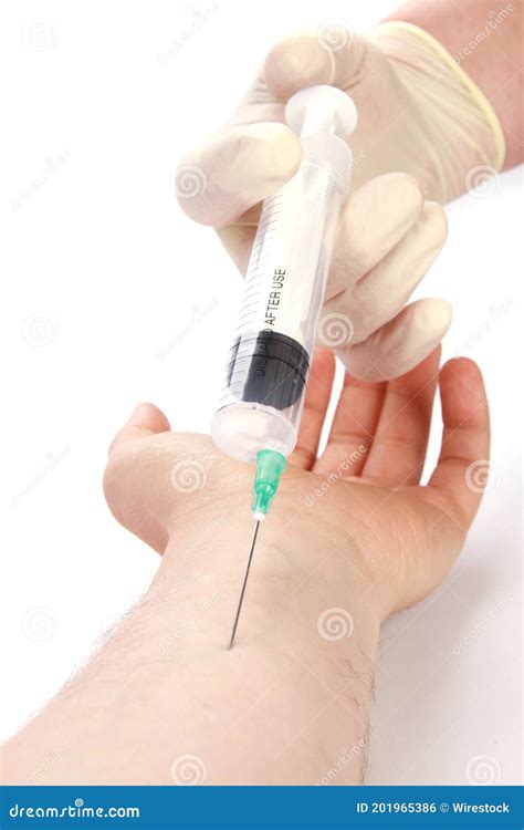 Vertical Shot Of A Doctors Hand Injecting A Syringe Into A Patients Arm