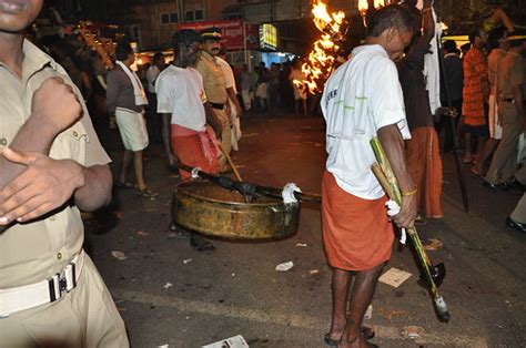 Two guys carry a huge vat of oil for the torches | With two … | Flickr