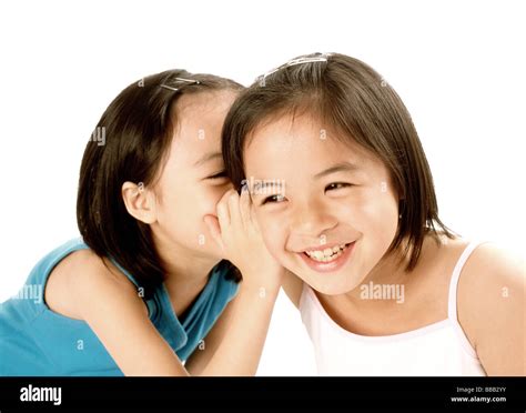 Two Young Girls Whispering To Each Other Hi Res Stock Photography And