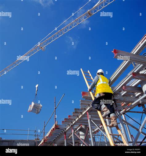 Construction Worker Climbing A Ladder Stock Photo Alamy