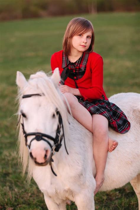 Portrait Of A Baby Girl Sitting On A White Pony Stock Image Image Of