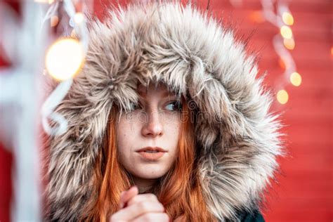 Portrait Of A Redhead Young Girl In Front Of A Red Garage Decorated With Lights Stock Image