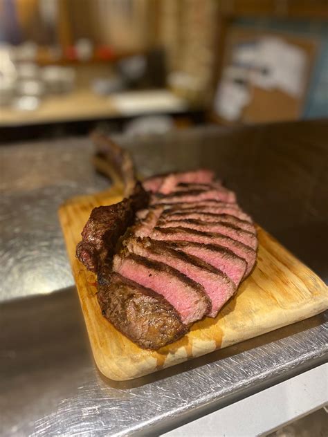 A Tomahawk Ribeye Steak Sliced And Cooked To Perfection Tomahawk