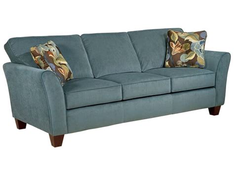 A Blue Couch With Two Pillows On The Armrests And One Pillow Is In