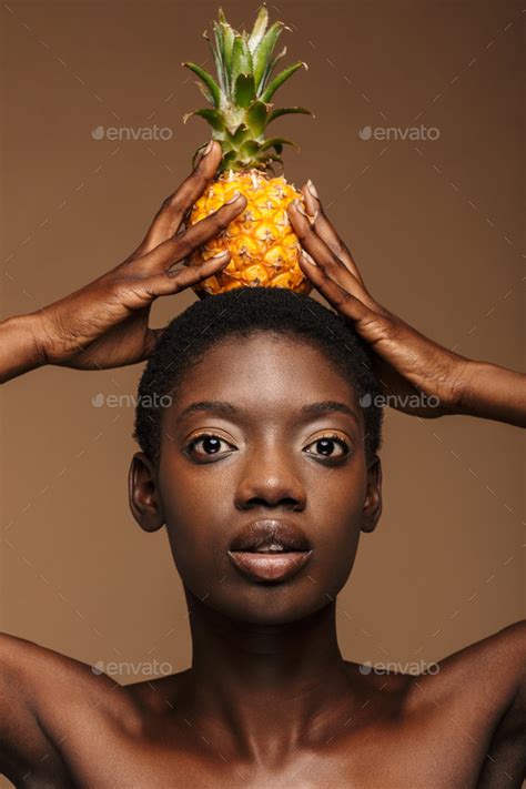 Beauty Portrait Of Half Naked African Woman Holding Pineapple On Her