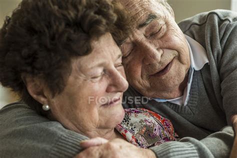 Happy Senior Couple Bonding At Home — Young At Heart Tenderness