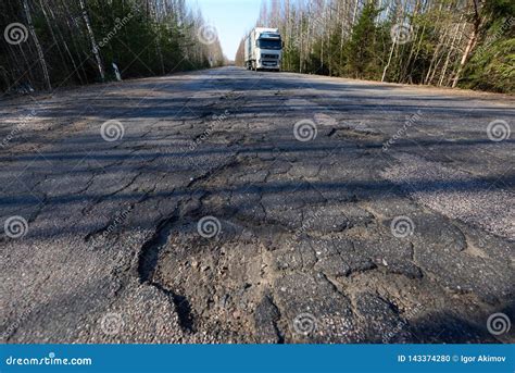 Highway With Potholes Poor Quality Pavement In The Primary Stage Of