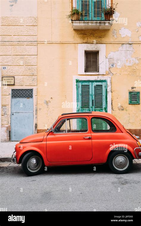 A Bright Orange Car Parked In Monopoli Puglia Italy Stock Photo Alamy