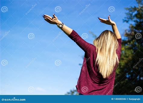 Cheerful Young Woman With Hands Raised Towards Sky Stock Photo Image