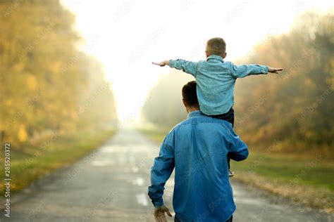 father and son walk in nature foto de stock adobe stock