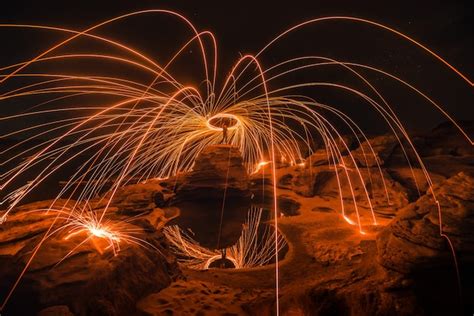 Premium Photo Burning Steel Wool On The Rock Near The River At Sam