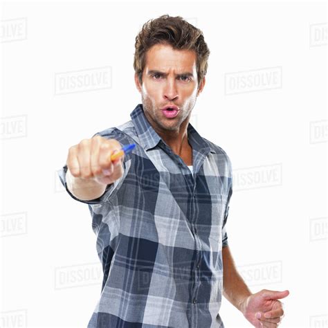 Studio Shot Of Young Confident Man Pointing With Pen At Camera Stock