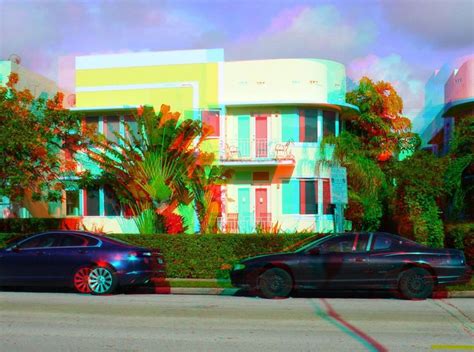 Two Cars Parked In Front Of A Multi Colored Building