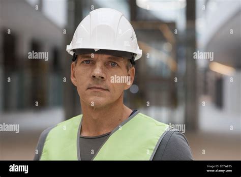 Close Up Portrait Of Professional Construction Worker Looking At Camera