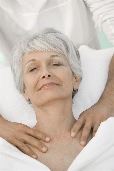 Senior Woman Enjoying Shoulder Massage At Spa The Garden Room