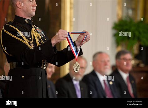 Military Aide To The President Ltc David Kalinske Displays A Medal