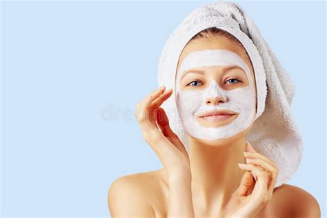 cosmetology skin care face treatment spa and natural beauty concept woman with facial mask