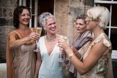 Elegant Mature Women Enjoying Champagne In Urban Garden Stock Photo Dissolve