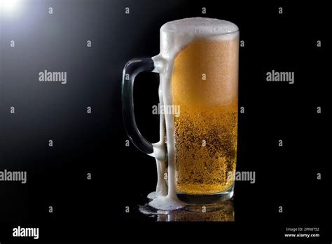 Cold Beers With Foam Drops On Dark Background Pouring Foam On The