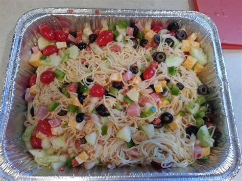 Combine the pasta with 3 stalks of celery that have been diced finely, 3 sliced green onions, 1 grated carrot and 1/4 cup (60 ml) of your favorite bottled italian dressing. Spaghetti Salad- Angel hair pasta, tomatoes, onion, green ...