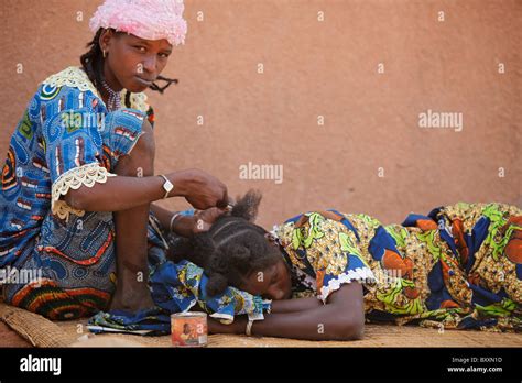 In The Town Of Djibo In Northern Burkina Faso A Young Woman Braids Her