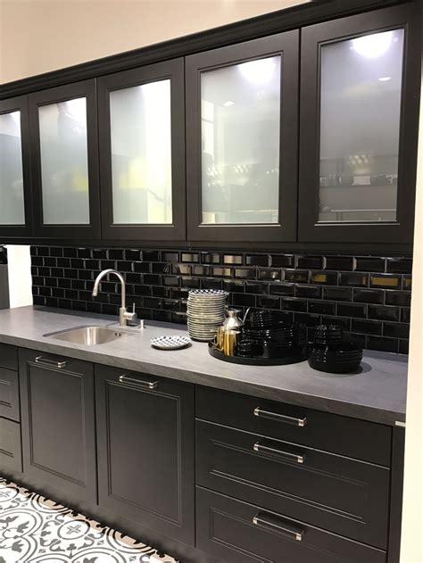 Black kitchen cabinets with subway tiles and white frosted glass. Black kitchen cabinets with subway tiles and white frosted ...
