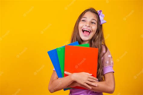 Premium Photo Beautiful Smiling Girl Holding Books Going To School