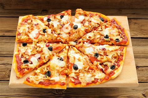 Al Funghi Pizza with Olives Cut in Sectors on Wooden Board Stock Image ...