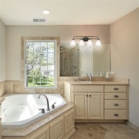 Measure 3 inches from the top of the mirror or 7 feet vertically from the floor if the mirror is not already in place. Illuminate your bath area with a simple but elegant bath ...