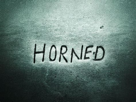 Written By Pencil The Word Horned On The Rough Dark Page Stock Photo
