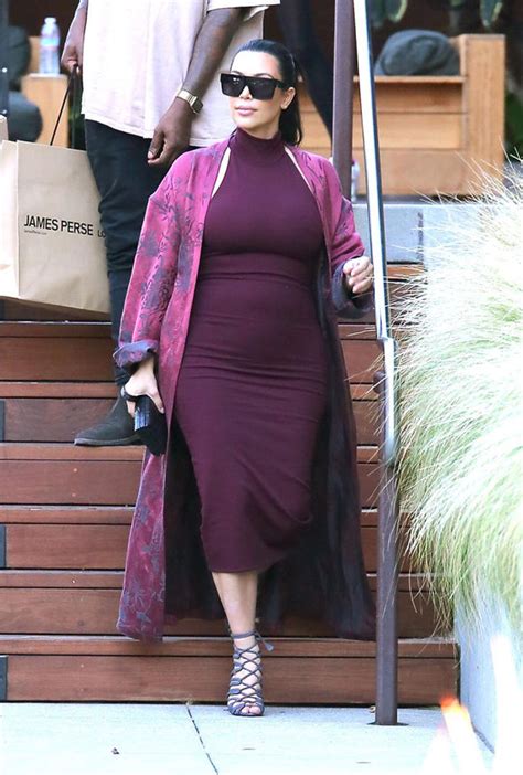 Kim Kardashian Pregnant Squeezes Growing Bump Into Skintight Dress