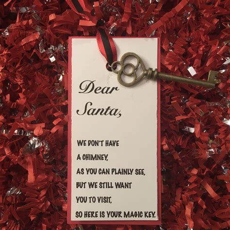 A Key Hanging From A Red Ribbon Next To A Card With The Words Dear Santa