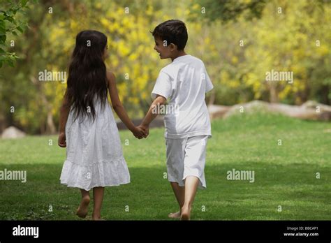 Two Children Holding Hands Walking Stock Photo Alamy