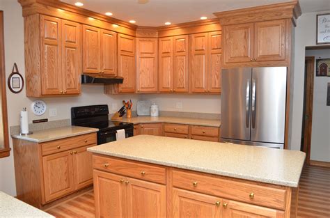 A Large Kitchen With Wooden Cabinets And Stainless Steel Appliances In