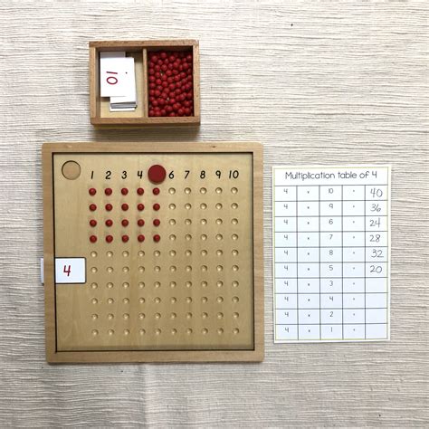 A Wooden Peg Board With Red Balls In It Next To A Calendar And Pen Holder