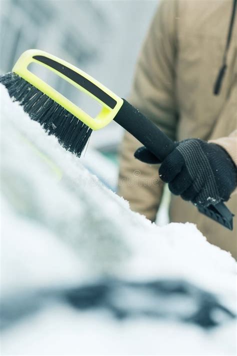 Man Cleaning Snow From Car Windshield With Brush Stock Image Image Of