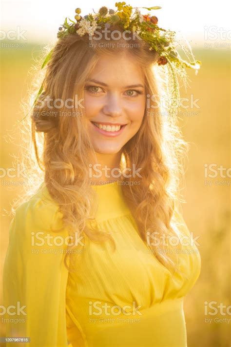 Happy Young Beautiful Woman Wearing Flower Garland In Fields With