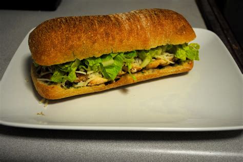 Panko chicken breast, marinara, provolone and arugula in a tuscan roll. slice of life: grilled chicken sandwich with arugula pesto