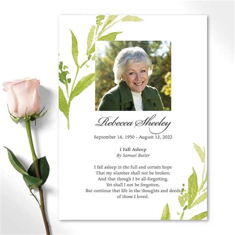 The Funeral Card Is Next To A Pink Rose And Green Leaves On A White Background