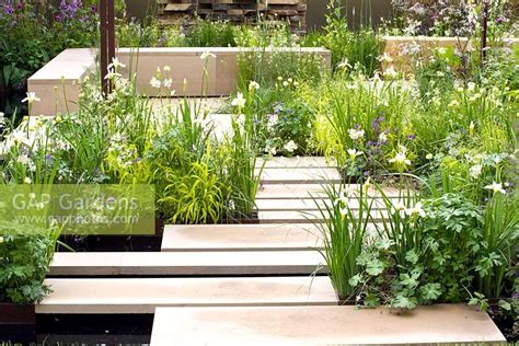 The dining area is on a paved section. Modern water garden ... stock photo by Elke Borkowski ...