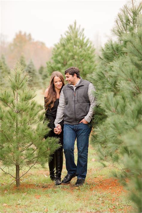 Engaged Couple Walking On A Christmas Tree Farm By Nj Engagement