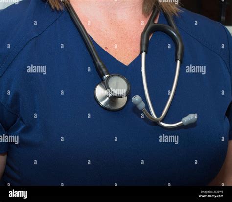 Partial Body Shot Of A Female Nurse Wearing Stethoscope Around Neck